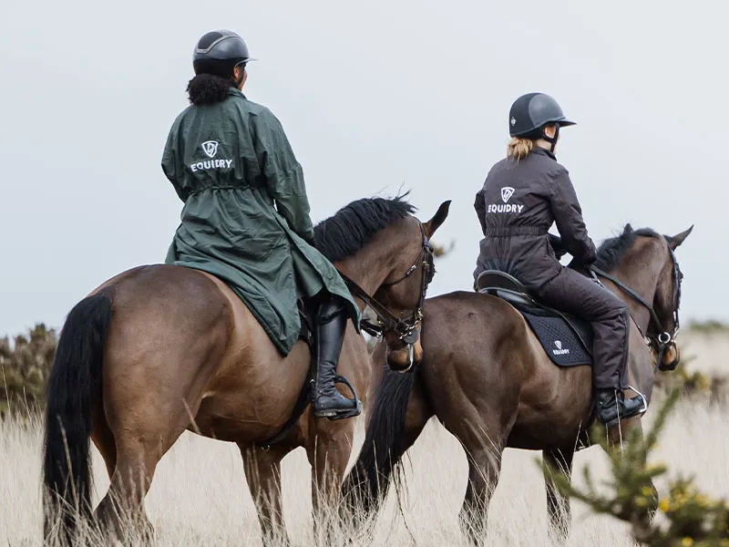 Two People Riding Horses Wearing EQUIDRY